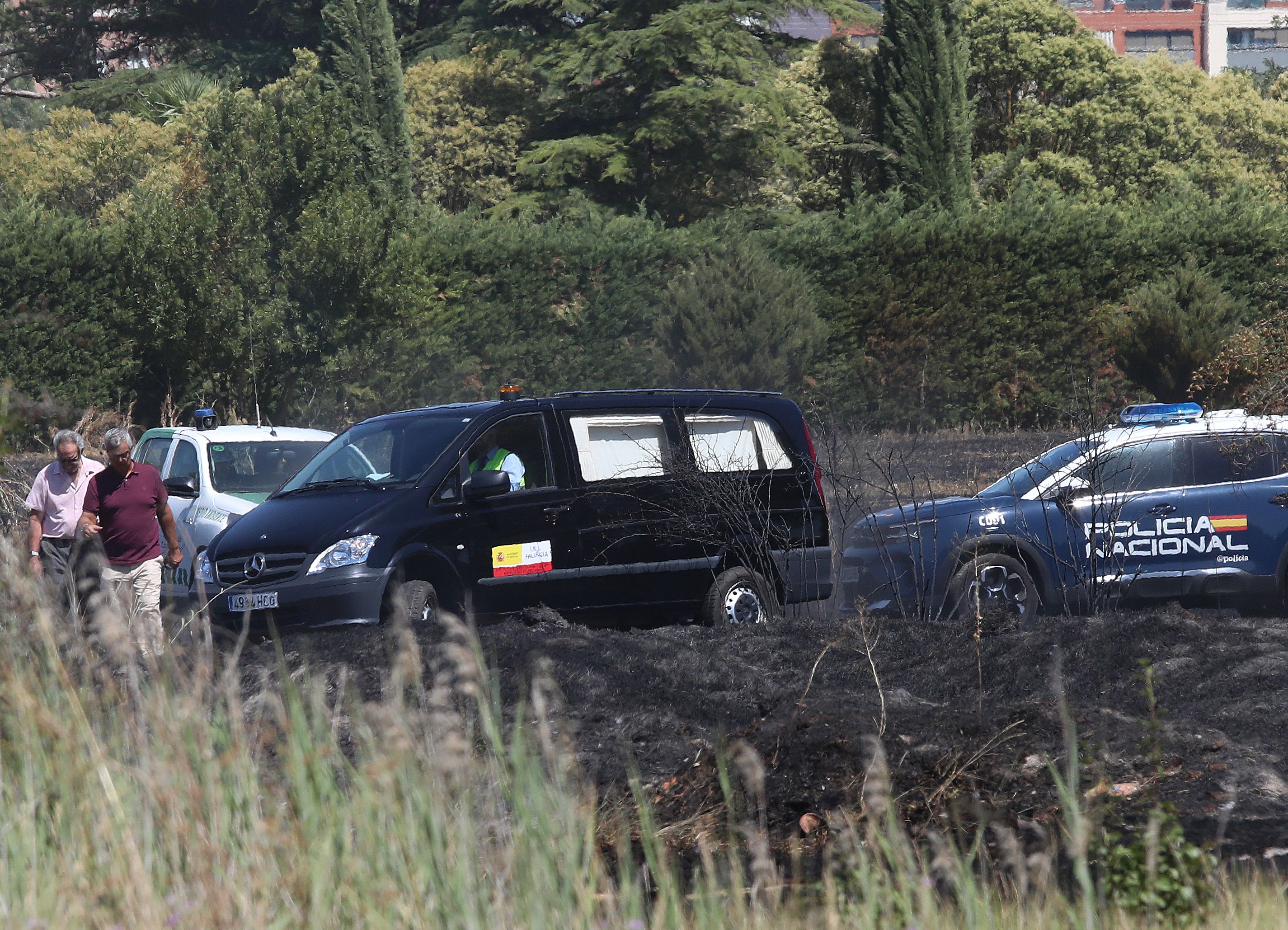 Brágimo  ICAL . El furgón del servicio forense abandona el lugar donde ha aparecido el cadáver de un hombre de 79 años entre los restos del incendio en una tierra de cultivo en Palencia