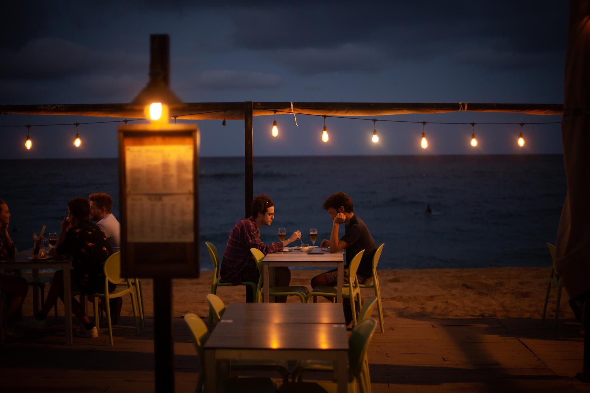 Dos jóvenes en la terraza de un restaurante frente a la playa   David Zorrakino   Europa Press   Archivo