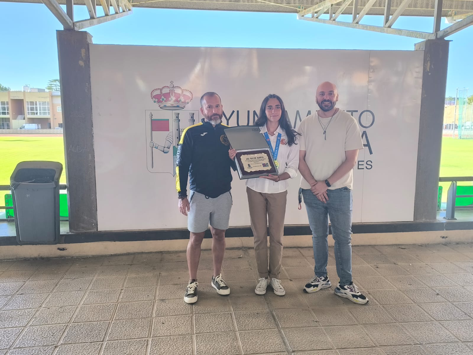 Ana Bailón muestra con orgullo la placa de reconocimiento y la medalla de oro