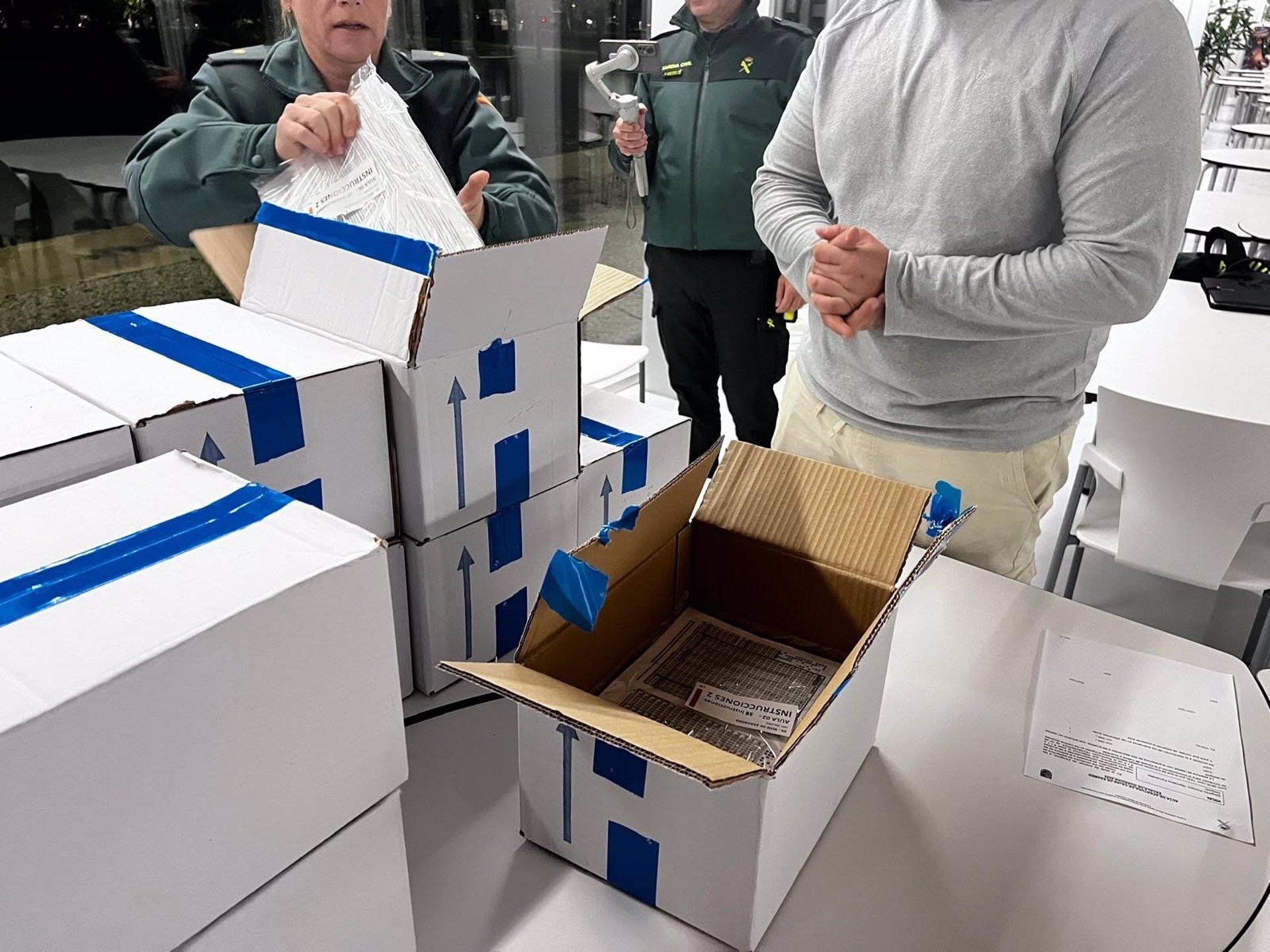 Agentes de la Guardia Civil custodian y comprueban las cajas que contienen las pruebas de oposición para ingresar al Instituto Armado - GUARDIA CIVIL